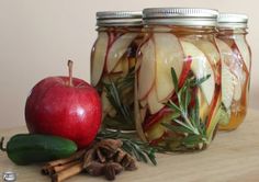 three jars filled with sliced apples and spices