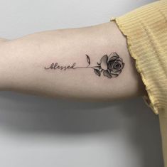 a woman's arm with a rose tattoo on it