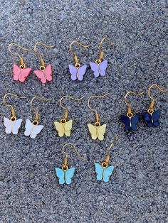 These cute butterfly earrings are great for special occasions and birthdays gifts, they come in several colors: Turquoise, Lavender, White, Yellow, Black, and Pink -Quality material: made of alloy and acrylic, these gold-plated butterfly pendants are durable, not easy to fade and rust, which won't cause irritation to skin easily, and can remain its shiny appearance for a long time; The earring hooks and jump rings are made of stainless steel. They're comfortable to wear for the reason that the charms are light weight, which is enjoyable for day-to-day activities Cute Butterfly Jewelry For Pierced Ears, Cute Butterfly Gold Earrings, Cute Gold Butterfly Earrings, Cute Gold Butterfly Jewelry, Summer Butterfly Charm Earrings, Summer Butterfly Charm Earrings For Gift, Elf Ear, Polka Dot Earrings, Aesthetic Earrings