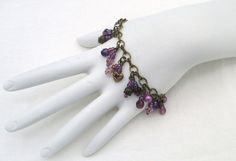 Purple Beaded Cluster Bracelet 7", with chain extension to 8", made with glass beads, antique gold-layered beads, brass beads, chain, and lobster clasp. This Purple Beaded Cluster Bracelet will ship to you in a gift box, securely mailed in a padded envelope. Shipping same or next day, thru USPS Ground Advantage, tracking and insurance included. Once mailed, you can track your package at USPS.com. If you don’t love your new treasure, you have 30 days to return it. Back to Bracelets. Purple Bead Necklace, Cluster Bracelet, Wearable Art Jewelry, Cluster Bracelets, Purple Beaded, Beads Chain, Long Drop Earrings, Cluster Necklace, Beaded Accessories