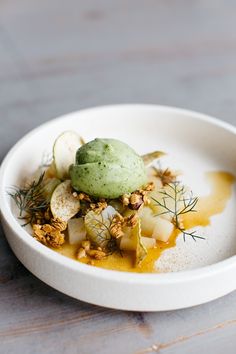 a white bowl filled with food on top of a wooden table