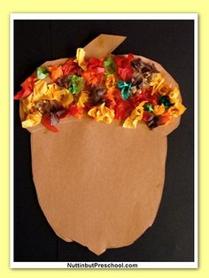 a paper bag filled with candy and candies on top of a black tablecloth