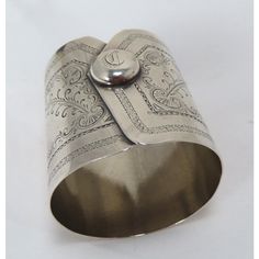 This is a Great Looking and Very Unusual Antique American Victorian Era Coin Silver Napkin Ring. Circa Mid 1860s to Early 1870s. It is Made in the Style of a Gentleman's Shirt - Coat Sleeve Cuff Complete with the Cuff Button. This is a Completely Hand Made - Bench Made piece of Silver - Would have been made by a Local Town - City Silversmith. The Cuff Button ( Cufflink ) ia Engraved with the Single Monogram "D". It has no maker or no silver mark but it has been professionally tested and is absol Silver Napkin Rings, American Coins, Mens Cuff, Aesthetic Things, Napkin Ring, Sleeve Cuff, Silver Cuff, Victorian Era, Napkin Rings