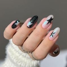 a woman's hand with black and white manies, stars on the nails