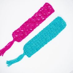 two crocheted headbands with tassels on them