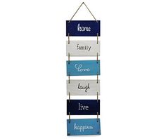 a wooden sign hanging from the side of a white wall with words on it that read home, family, love, laugh, live