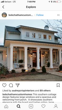 a white house with columns and lights on the front porch