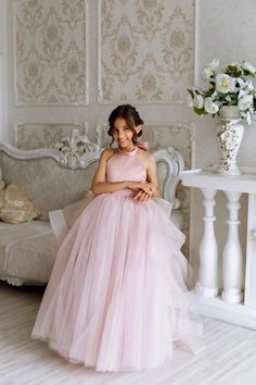 Introducing the enchanting Gwenevere Ruffled Tulle & Satin Flower Girls Dress, a masterpiece designed to transform any special occasion into a fairy tale. This exquisite dress is crafted with the utmost attention to detail, featuring a smooth satin halter neckline that cascades into a mesmerizing sea of ruffled tulle, ensuring your little angel feels nothing short of a princess. The pièce de résistance? An oversized, decorative satin bow at the back of the neck, adding a touch of grandeur and so Baby Christening Outfit, Flower Girls Dress, Girls Communion Dresses, Satin Flower Girl Dress, Wedding Party Flowers, Girls Crown, Flower Girl Crown, Christening Outfit, Girls Pageant Dresses