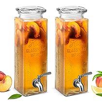 two glass jars filled with liquid next to sliced peaches