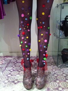 a woman's legs in tights with colorful polka dots on them and high heels