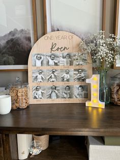 a table with some vases and pictures on it next to a shelf filled with cookies