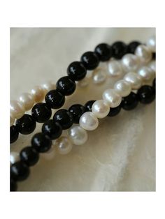 Experience the timeless contrast between black onyx and white pearls with this simple yet striking design. Natural pearls add a soft beauty, while black agate adds a unique charm. This necklace can be DIY by yourself. The two beads are scattered and have a sense of hierarchy. They are twisted together and have a sense of design Metal: 18ct Recycled Gold Plated On Brass Gemstone: Black Onyx Pearl: Freshwater Pearl (4-4.5mm) Length: 360-410mm Weight: 18g Black Pearl Necklace With Round Bead Pendant, Black Pearl Necklace With Pearl Pendant, Black Pearl Necklace With Pearl Charm, Black Pearl Drop Necklace, Black Pearl Drop Necklace With Round Beads, Black Pearl Necklace With Round Beads And Pearl Drop, Black Pearl Bracelet With Round Beads, Classic Black Necklace With Pearl Pendant, Classic Black Jewelry With Pearl Charm