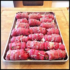 raw meat wrapped in white icing on a baking sheet ready to go into the oven