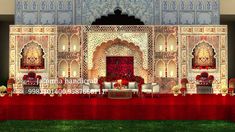 an elaborately decorated stage set up for a wedding reception with red and white decor