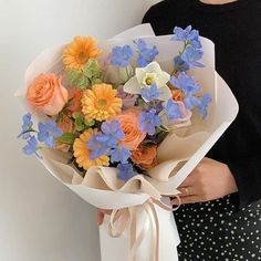 a woman holding a bouquet of flowers in her hands