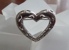 "This listing features a beautiful Vintage Sterling Silver Jezlaine Heart Pin. The pin has exquisite detailing featuring the hand pierced filigree design that Jezlaine is known for. The open work Jezlaine Heart is hard to find. This beautifully detailed HEART pin would be perfect for any collector! It is Jezlaine at its best. The closure is a rolling C clasp that is in perfect working condition. There is a beautiful patina to the pin. I have not polished the pin as many people prefer the natural Vintage Heart-shaped Wedding Brooches, Vintage Heart Brooch, Filigree Hoop Earrings, Hand Piercing, Dolphin Jewelry, Deer Fawn, Dolphin Earrings, Hanging Bell, Dog Brooch