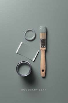 a paintbrush, tape and some other items on a gray surface with the words rosemary leaf