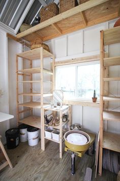 a room with wooden shelves and white walls