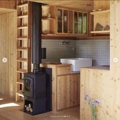 a wood stove sitting in the middle of a kitchen