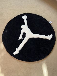 a black and white rug with a basketball logo on it