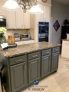 a kitchen with white cabinets and granite counter tops