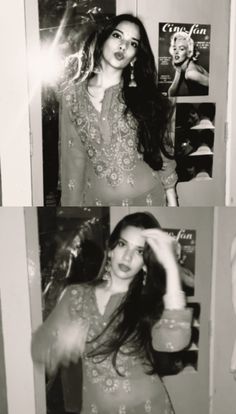 black and white photograph of woman in front of mirror with hair blowing out, looking at camera