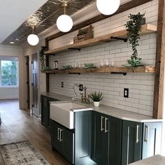 the kitchen is clean and ready to be used for cooking or baking, with open shelving above the sink