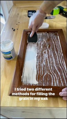 a person is using a brush to paint the wood on a piece of paper that says i tried two different method for filling the grain in my ink