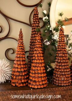 christmas trees made out of pine cones on a mantle