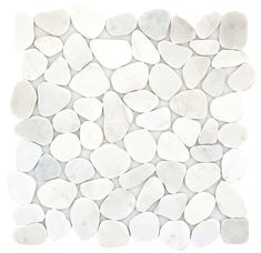 white pebbles are arranged in a pattern on the wall