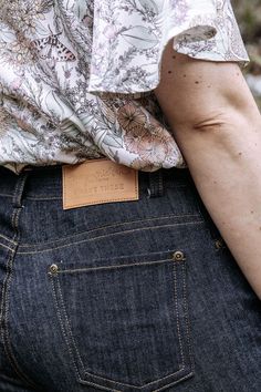 the back of a person's jeans with a leather tag on their left side