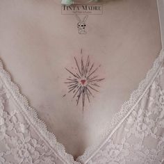 a woman's chest with a small tattoo on the top and bottom part of her stomach