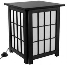 a small wooden table with white glass panels and a black cord plugged into it