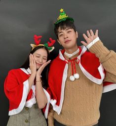 a man and woman dressed up in christmas costumes