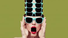 a woman with sunglasses on her head is making a funny face while covering her eyes