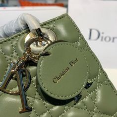 Description CHRSTN DR Small Lady DYOR Bag Gold toned hardware Olive Green For Women 8in/20cm CD Rep 1:1 Measurements: 20 x 16.5 x 9 cm / 8 x 6.5 x 3.5 inches The Lady DYOR handbag epitomizes the House’s vision of elegance and beauty. Refined and sleek, the timeless creation is crafted in blush and covered with Cannage stitching, creating an instantly recognizable quilted texture. The pale gold-finish metal ‘D.I.O.R.’ charms embellish and illuminate its silhouette. Featuring a removable shoulder Lady Dior Handbag, Louis Vuitton Shirt, Chanel Shirt, Small Lady, Dior Handbags, Luxury Products, Pale Gold, Evening Clutch Bag, The Lady