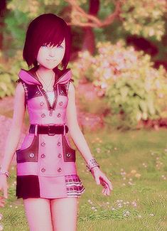 a girl in a pink dress walking through the grass with her hand on her hip