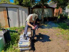 a man sitting on top of a box in the dirt