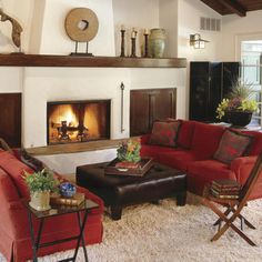 a living room filled with furniture and a fire place in the middle of the room