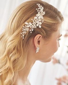 a woman wearing a bridal hair comb with flowers on it's back side