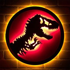 a neon sign with a dinosaur head on it's side in front of a brick wall