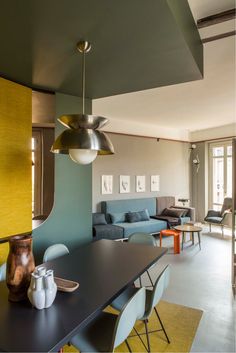 a living room filled with furniture next to a dining table