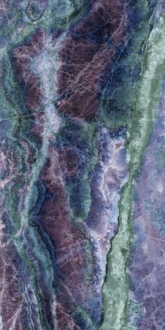 an aerial view of the earth's terrain and its colors, including blue, green, brown, and white