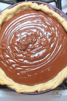 a chocolate pie sitting on top of a stove