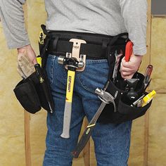 a man holding tools in his belt