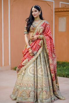 a woman in a red and gold bridal gown