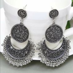 Bead Tassel Drop Chandbali Jhumka Earrings Material - Metallic With Good Quality Color - Silver Style - Dangle Details - Round Eardrop Height - 2.8” Eardrop Width - 1.4” Care Instruction : Avoid Heat & Chemicals Like Perfume, Deo, Alcohol Etc. Clean With Dry Cotton Cloth. Pack In Air Tight Container After Use. Silver Bohemian Chandelier Earrings With Tassels, Silver Bohemian Tassel Earrings, Traditional Tassel Chandelier Earrings For Festival, Silver Tassel Earrings For Festivals, Silver Bohemian Tassel Earrings For Festival, Bohemian Round Chandelier Earrings With Latkans, Traditional Tassel Earrings For Festival, Festival Tassel Earrings, Silver Bohemian Tassel Earrings With Dangling Beads