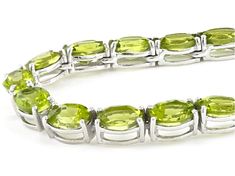 52.95ctw oval peridot rhodium over sterling silver tennis necklace. Measures approximately 3/16"W. Box clasp with safety. Lime Green Gemstone Jewelry For Formal Occasions, Formal Lime Green Gemstone Jewelry, Oval Peridot Jewelry For Formal Occasions, Formal Oval Peridot Jewelry, Silver Oval Peridot Jewelry, Silver Peridot Oval Jewelry, Oval Peridot Silver Jewelry, Box Clasp, Peridot Gemstone