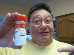 a man is holding up a flavy bottle in front of his face and pointing to the camera