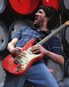 a man is playing an electric guitar on stage